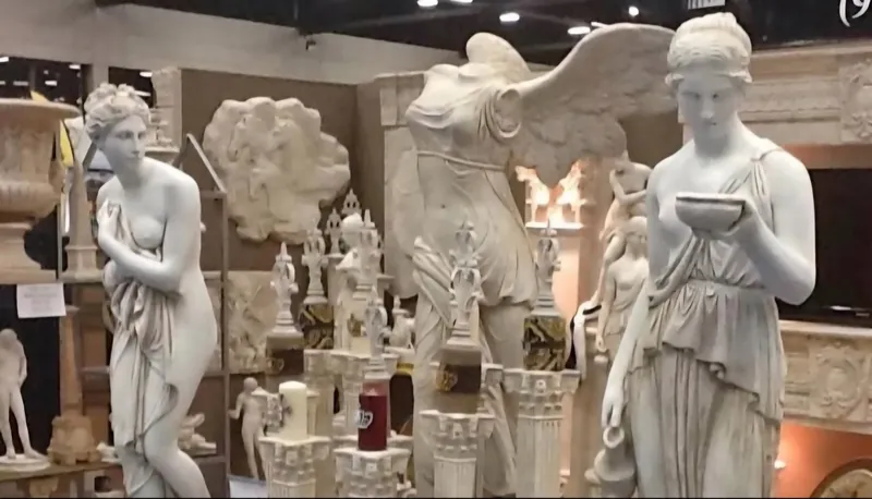 A gallery space lined with classical statues
