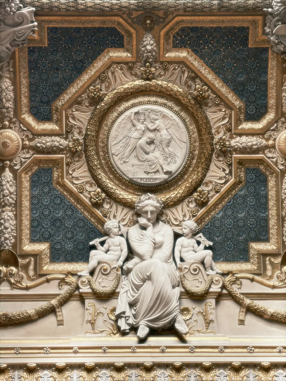Ornate gilded ceiling with a central sculpted relief